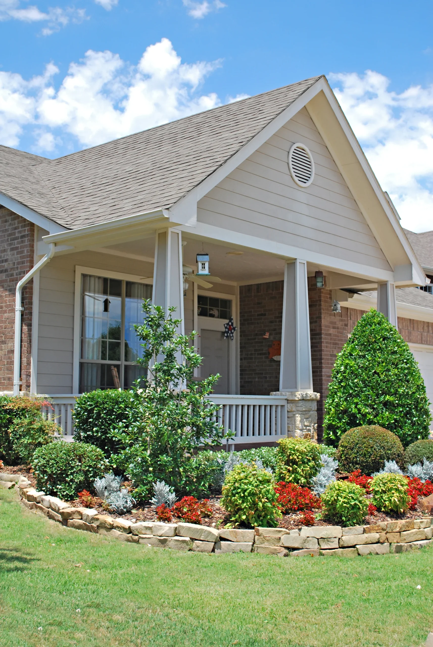 The front of a home with a garden in front.